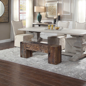 A solid wood bench, constructed from recycled boat wood. completing a dining room set up, featuring a luxury serving tray