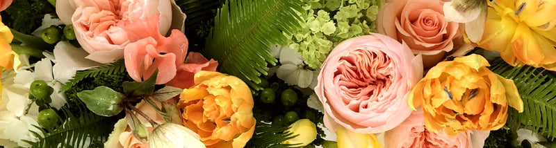 Beautiful set of yellow and pink roses, with some green ferms and olive branchs